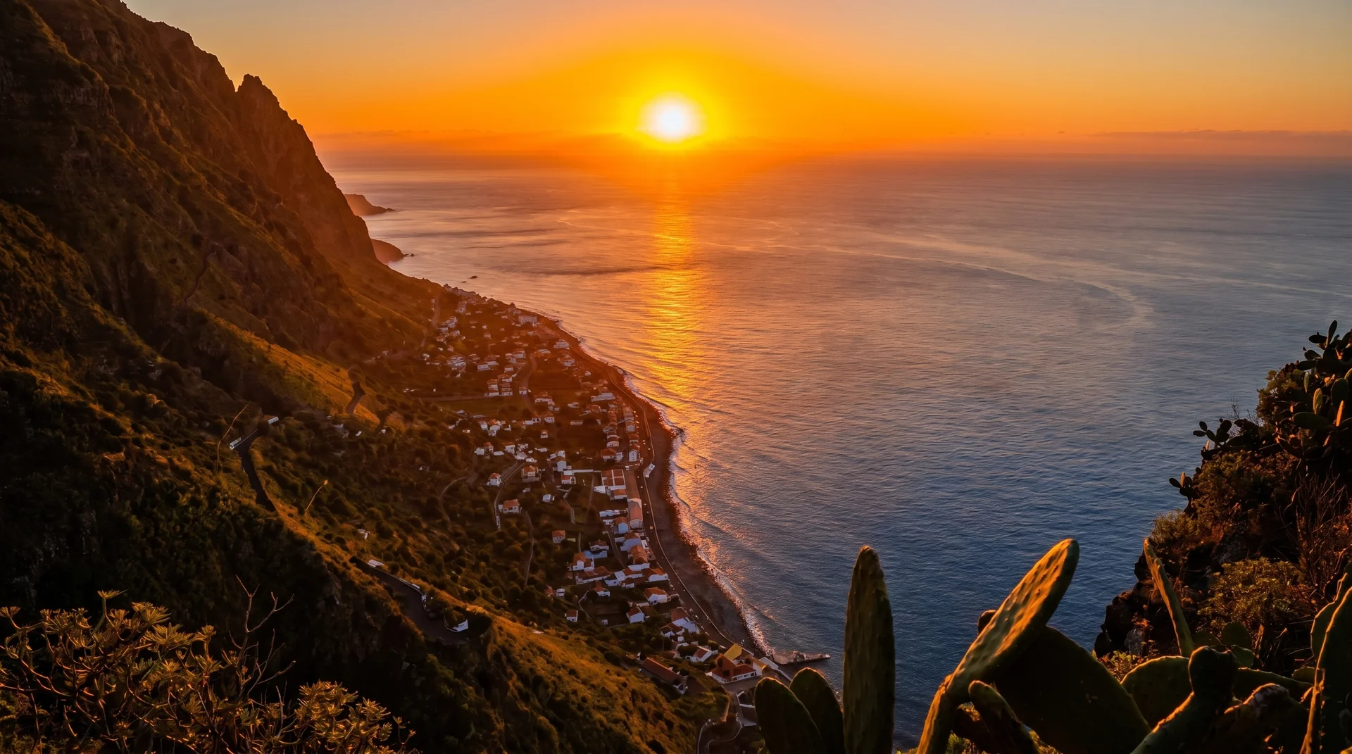 Fio viewpoint with sun setting over Paul do Mar village far below, Madeira